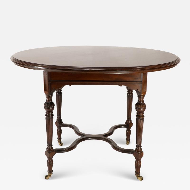  Collinson Lock Collinson Lock attributed An Aesthetic Movement walnut circular center table
