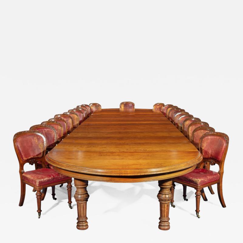  Gillows of Lancaster London An extensive burled figured pollard oak dining table and chair set by Gillows