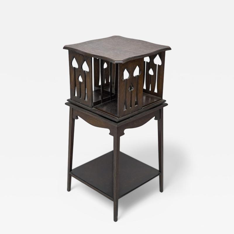 Liberty Co Liberty and Co An oak revolving bookcase with stylized floral cut out decoration