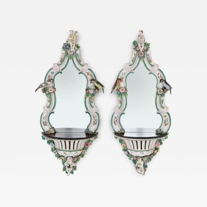  Meissen Porcelain Manufactory Pair of Meissen style porcelain and ebonised wood mirrored wall brackets