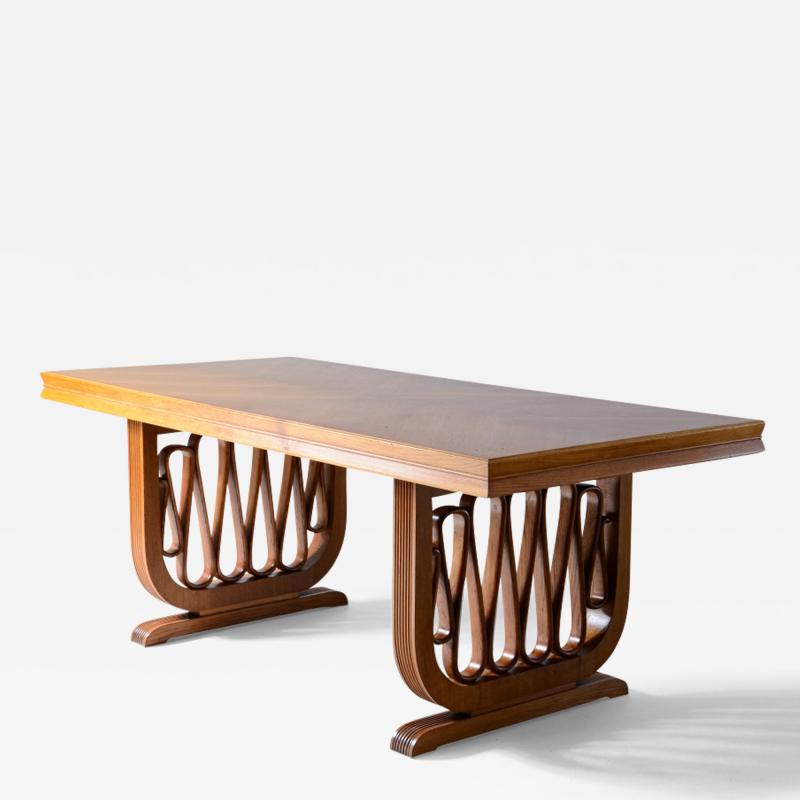  Pierluigi Colli Extraordinary oak table with shaped uprights and ribbon motif