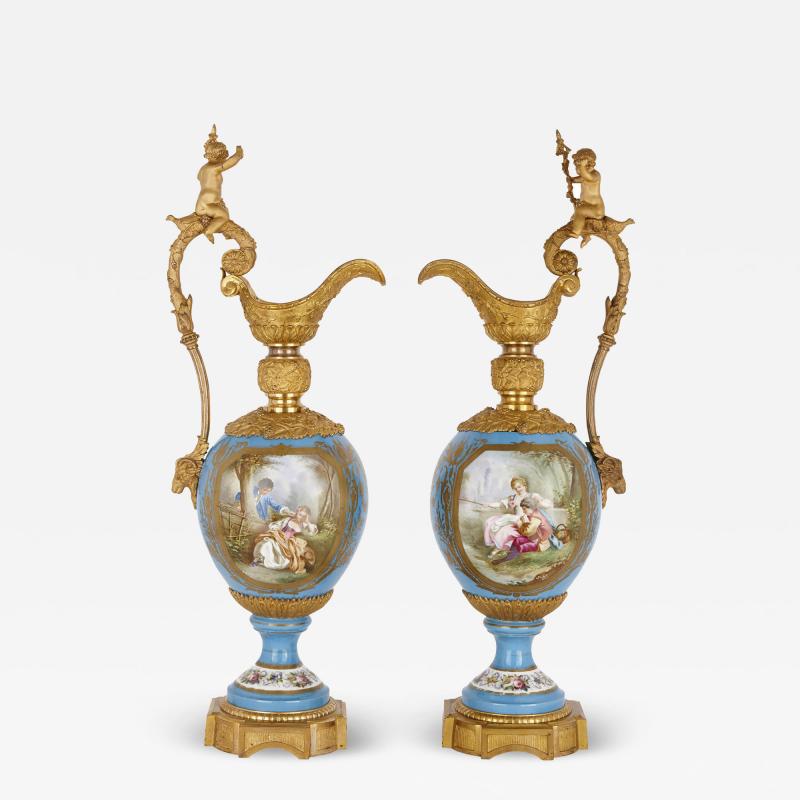  S vres Porcelain Manufactory Two large Rococo style porcelain and gilt bronze jugs