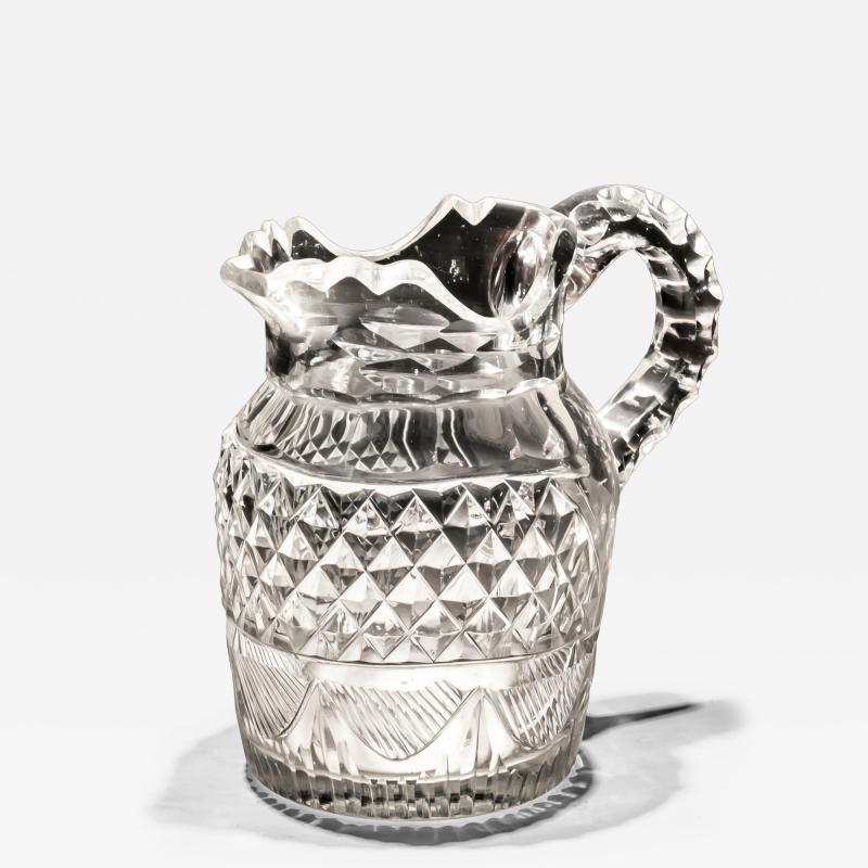 A CUT GLASS IRISH CREAM JUG