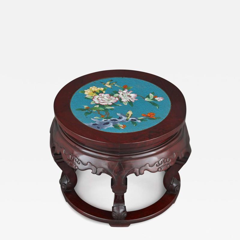 A Chinese cloisonn enamel inset circular carved hardwood pedestal