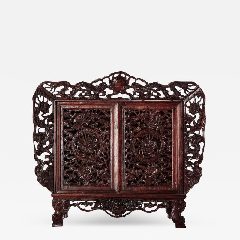 A Chinese small openwork wood cabinet depicting Dragons