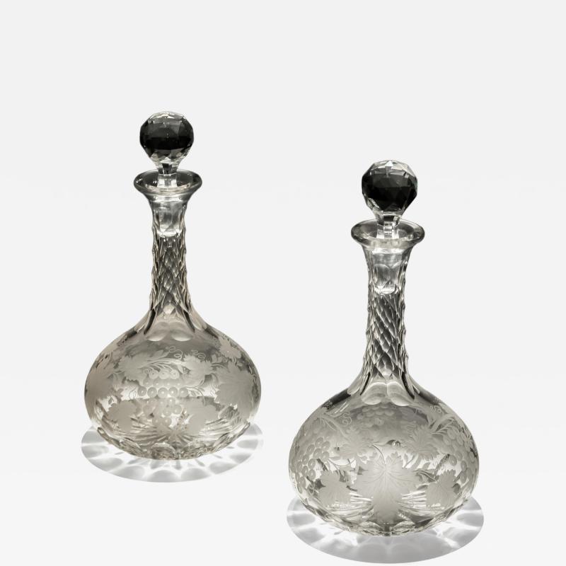 A FINE PAIR OF ENGRAVED SHAFT GLOBE DECANTERS