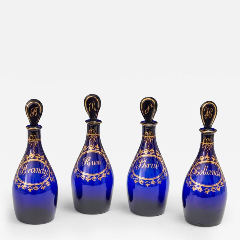 A FINE SET OF FOUR BRISTOL BLUE GILT LABEL ANTIQUE GEORGIAN DECANTERS