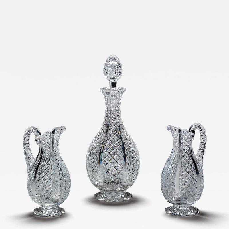 A FINELY CROSSOVER DIAMOND CUT DECANTER WITH MATCHING PAIR OF JUGS