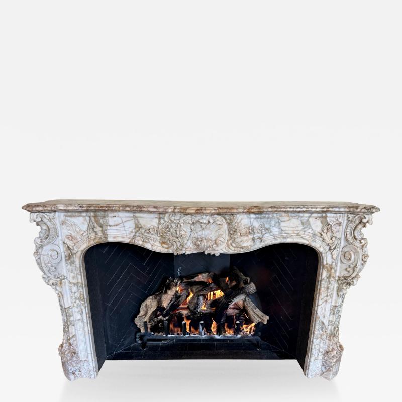 A Finely Carved Louis XV Style Fireplace Mantel in Figured Italian Marbl