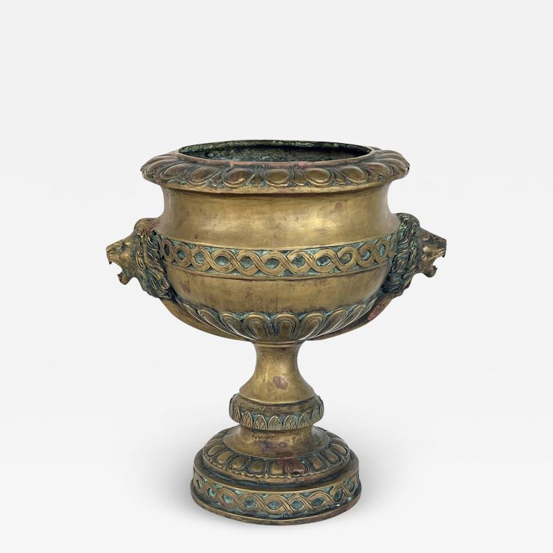 A French Louis XVI Style Brass Pedestal Urn with Lion Mask Handles