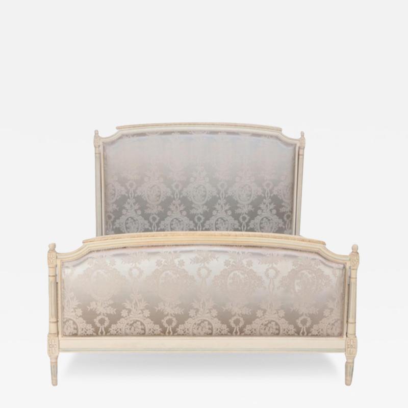 A French Louis XVI style painted and upholstered full size bed C 1940 