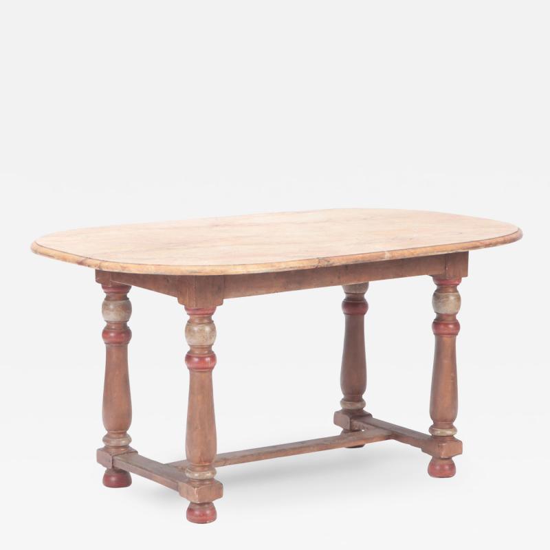 A French faux marble top table resting on an early 19th C base 