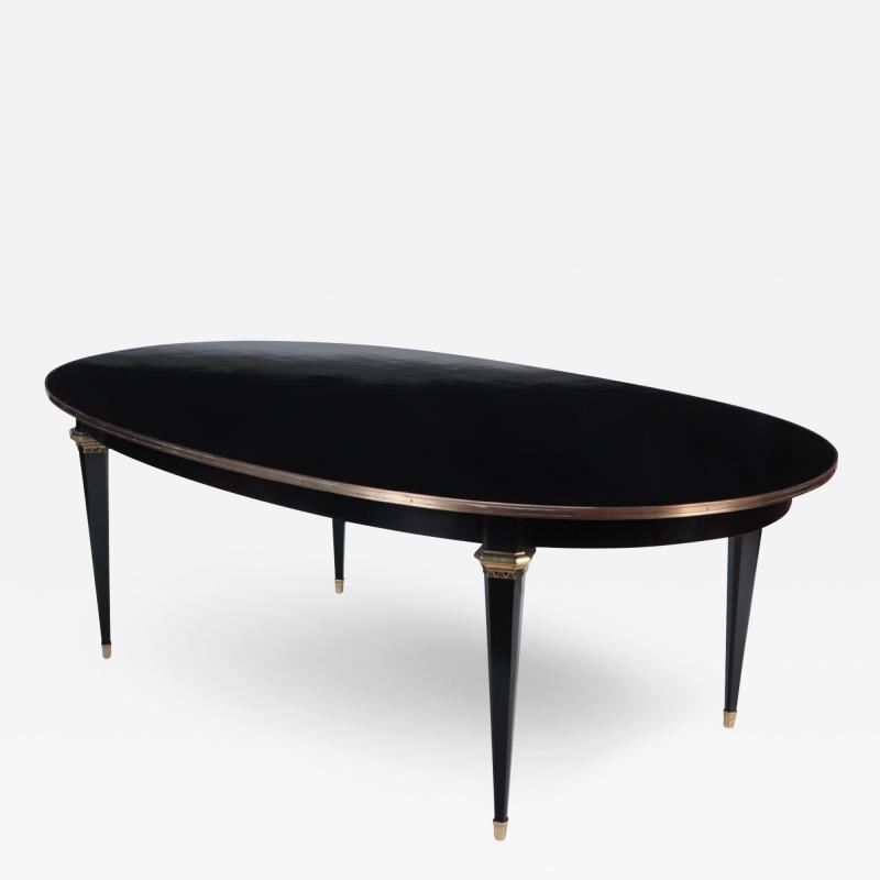 A French oval ebonized mahogany dining room table circa 1940 