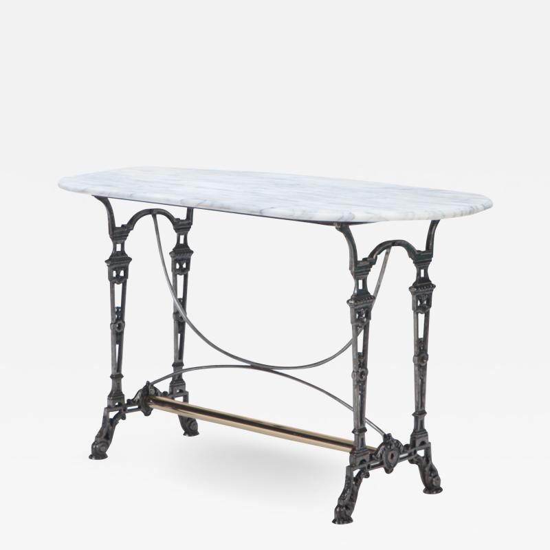A French polished iron and marble top bistro table