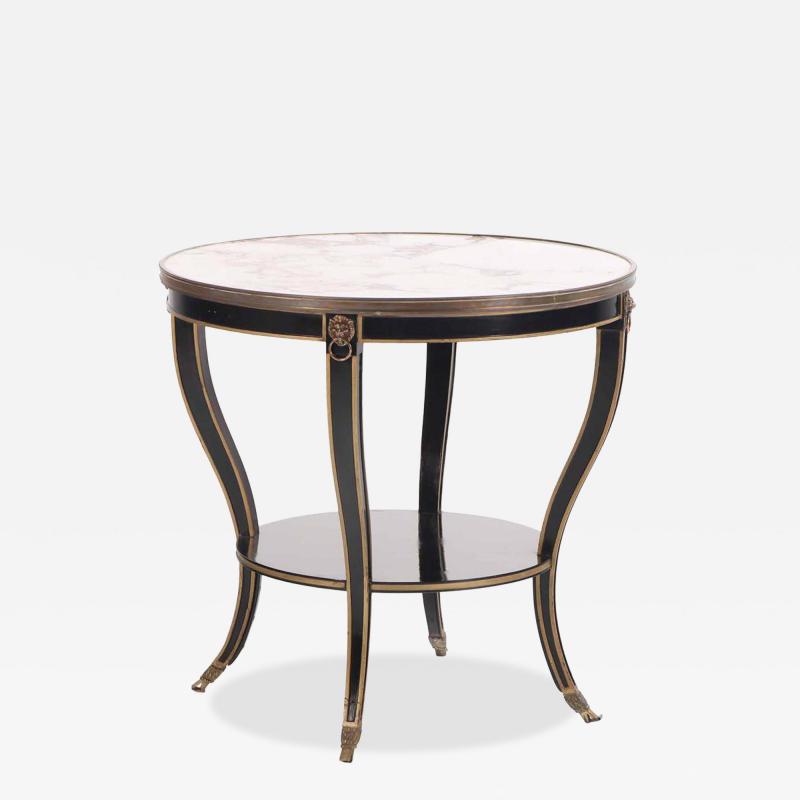 A French round marble top ebonized and gilt table C 1940 