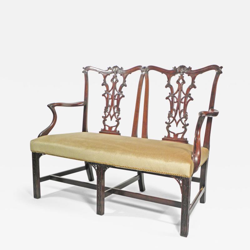 A GEORGE II MAHOGANY SETTEE BY GILLOWS