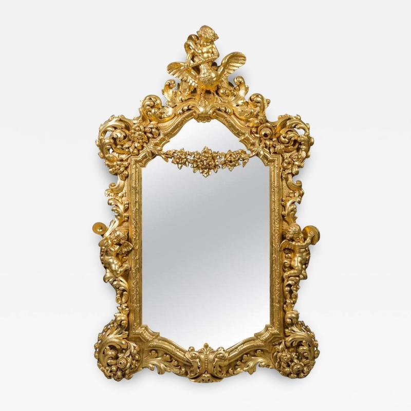 A LARGE FRENCH ROCOCO STYLE GILT WOOD FIGURAL WALL MIRROR