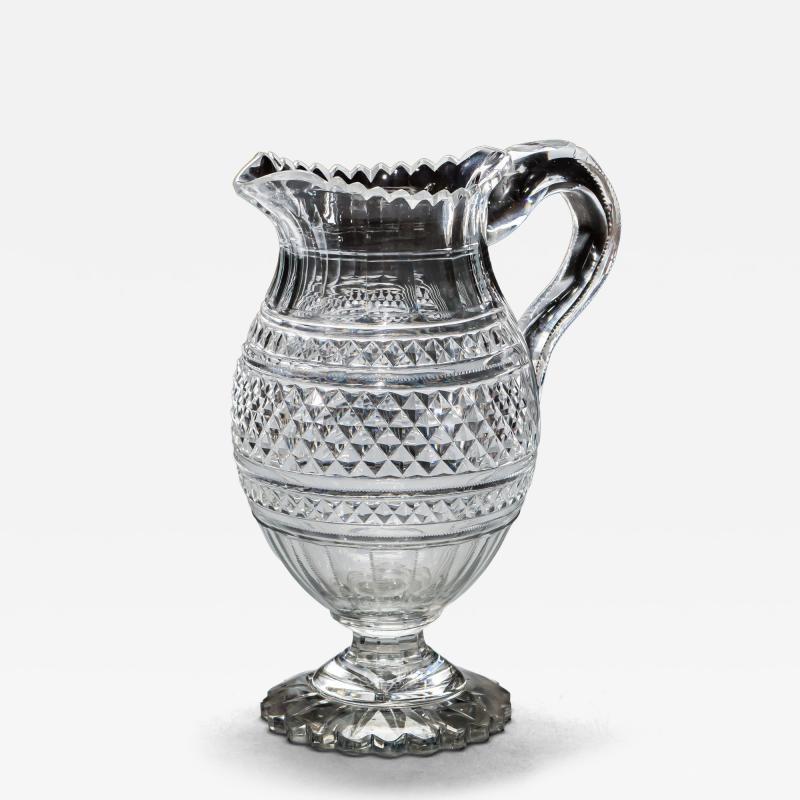 A LARGE PEDESTAL WATER JUG