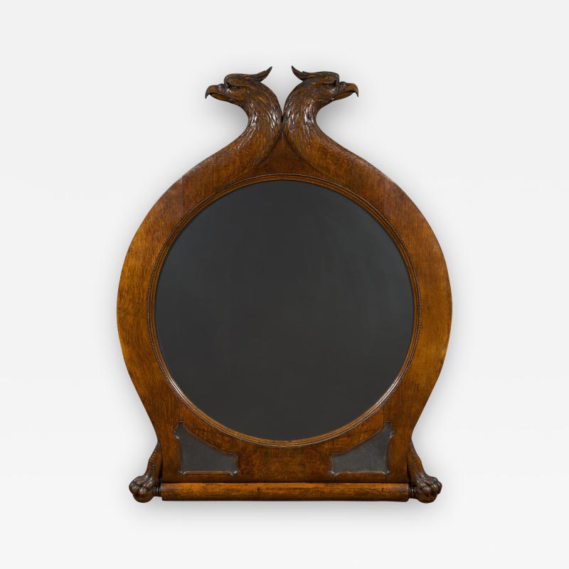 A Large Carved Oak Mirror Surmounted By Addorsed Eagle Heads