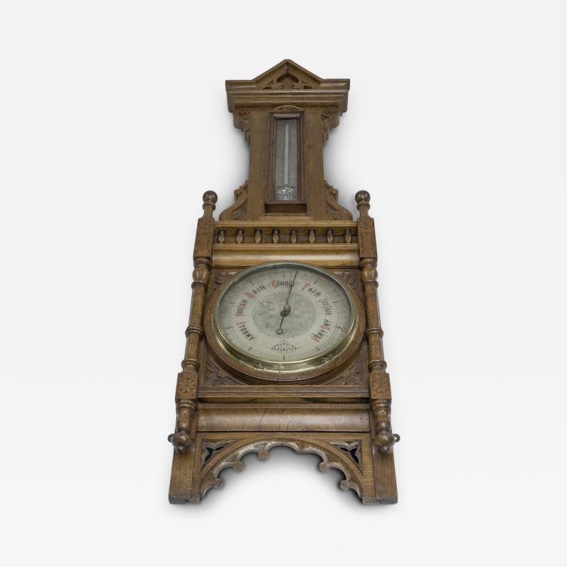 A Large Gothic Revival Carved Oak Barometer with a Rare Snail Tail Thermometer