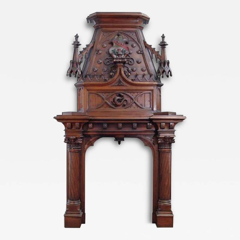 A MONUMENTAL ENGLISH GOTHIC STYLE CARVED WALNUT FIREPLACE