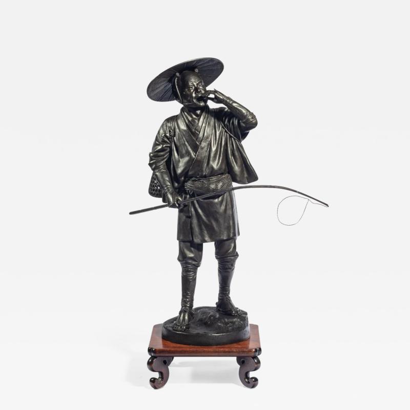 A Meiji period bronze of a cricket catcher