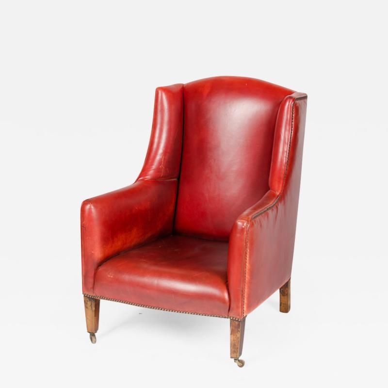 A Mid Century English red leather club wingback armchair circa 1960