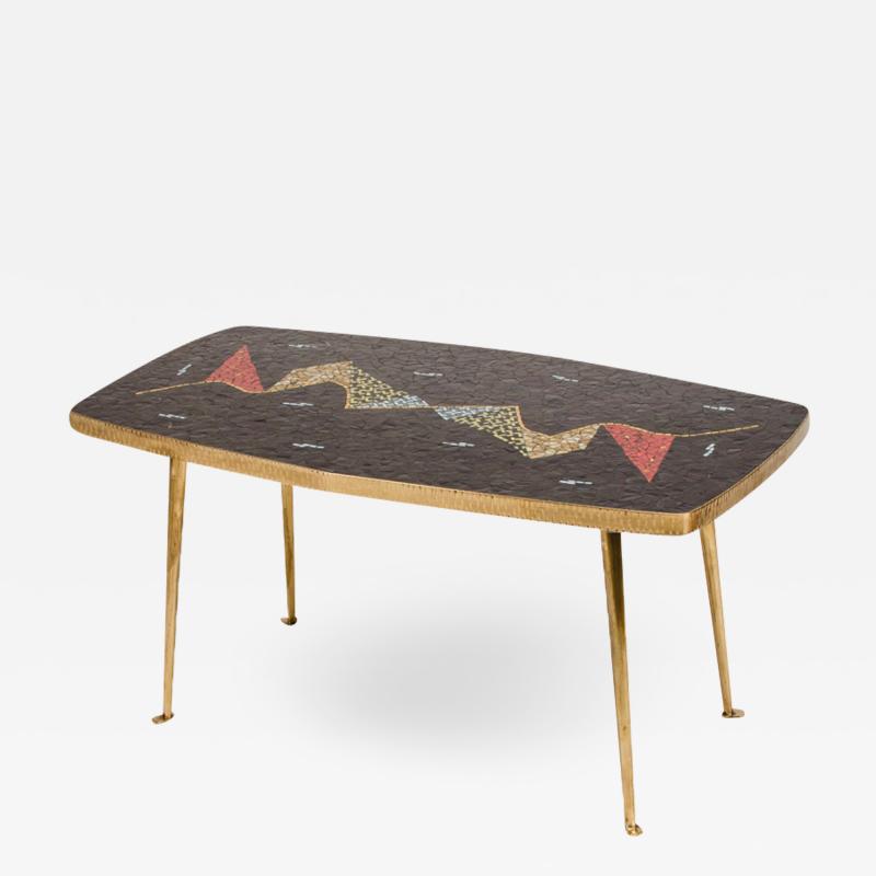 A Mid Century German coffee table with a mosaic top on brass metal legs