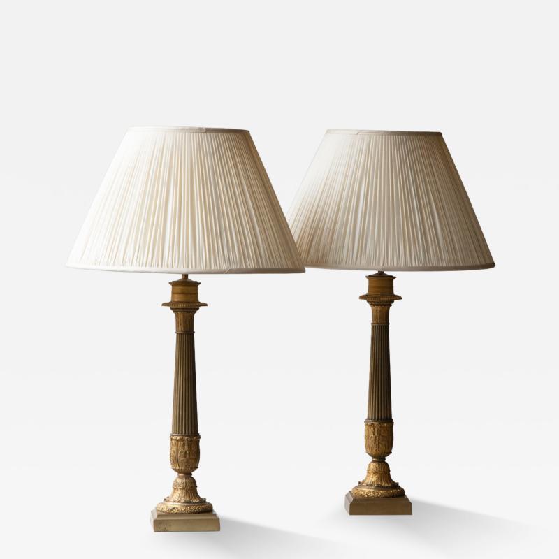 A PAIR OF 19TH CENTURY GILT CANDELABRA CONVERTED TO LAMPS