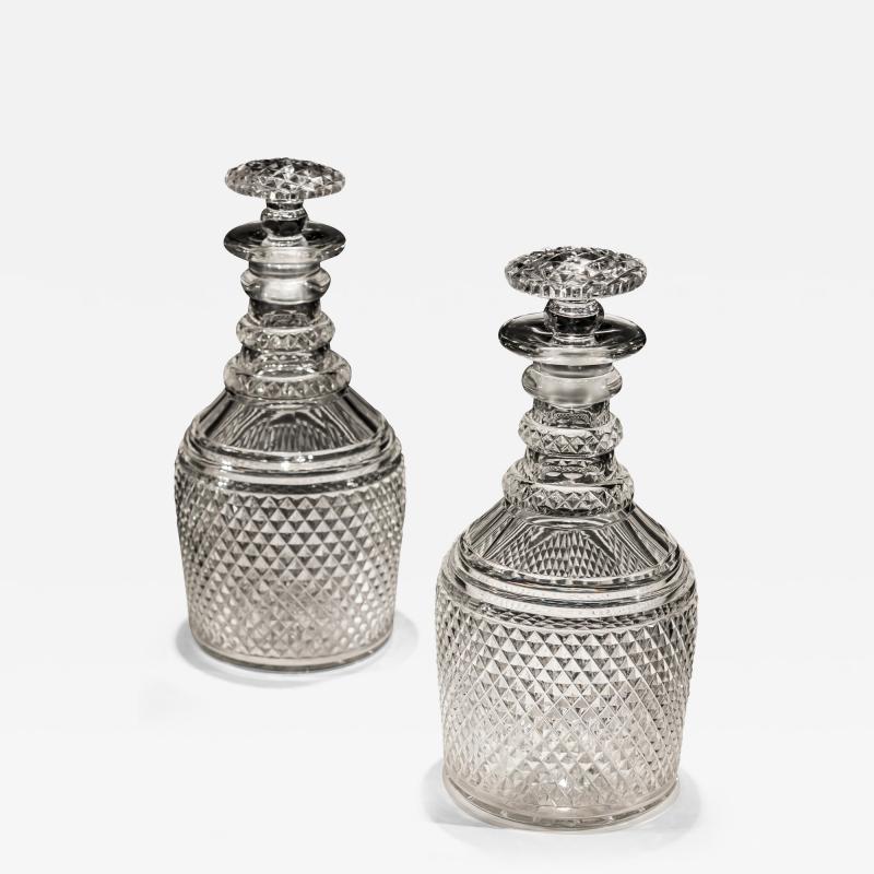 A PAIR OF DIAMOND CUT REGENCY ANTIQUE DECANTERS