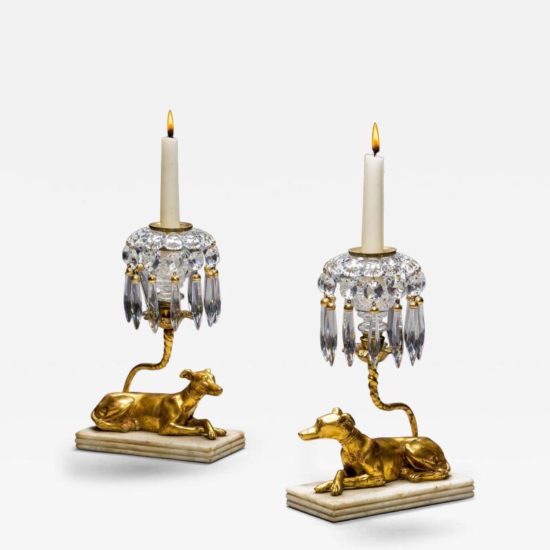 A PAIR OF GILT WOOD GREYHOUND CANDLESTICKS