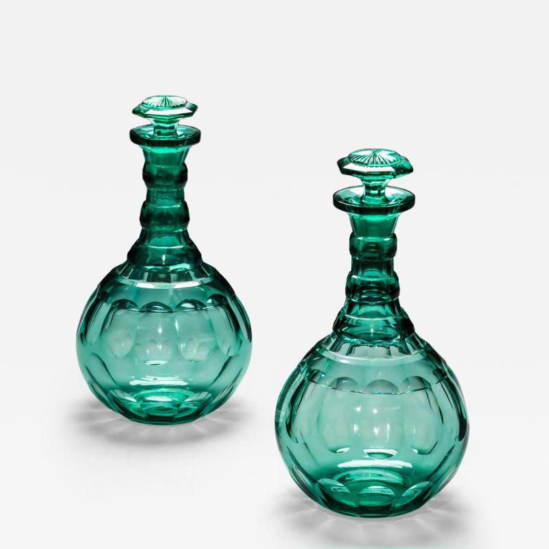 A PAIR OF GREEN SHAFT GLOBE DECANTERS