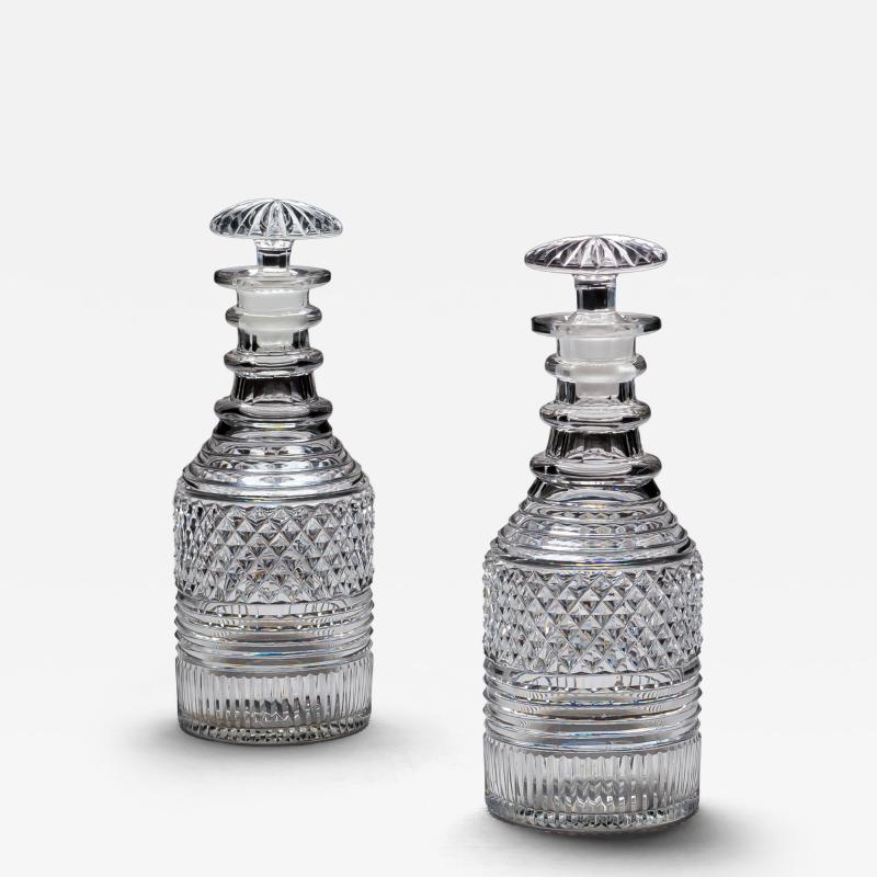 A PAIR OF HEAVILY CUT REGENCY SPIRIT DECANTERS