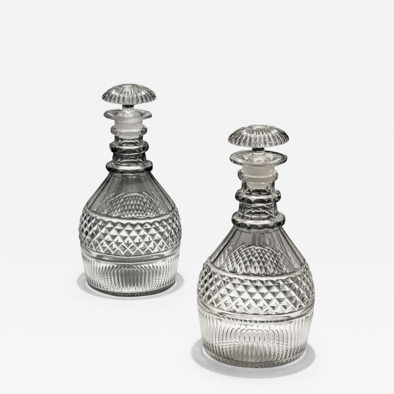 A PAIR OF REGENCY SLICE FLUTE DECANTERS WITH DIAMOND CUT BAND