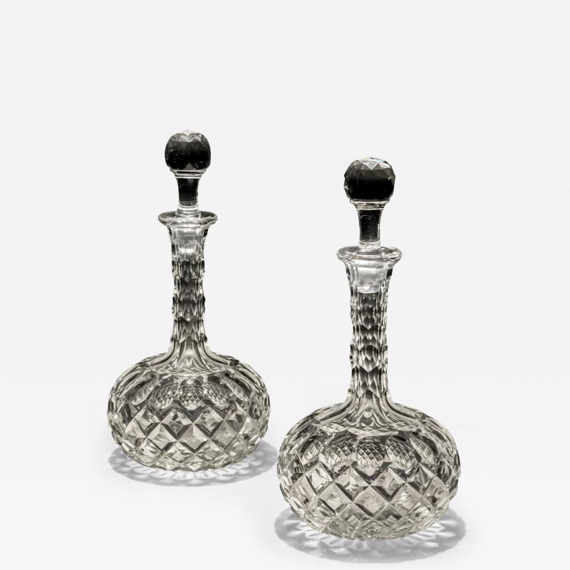 A PAIR OF SHAFT GLOBE VICTORIAN DECANTERS