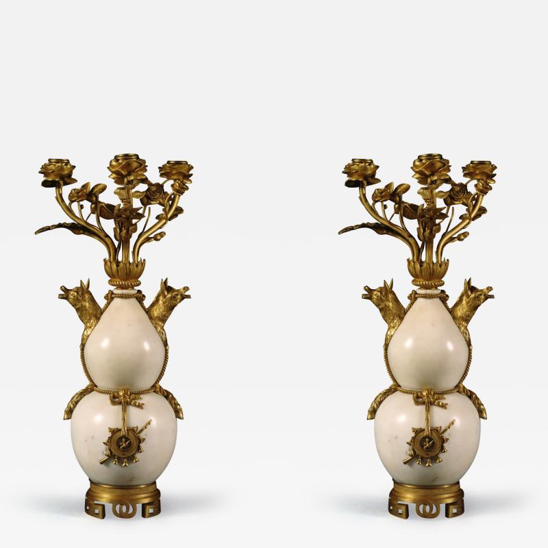 A PAIR OF STATUARY MARBLE AND GILT BRONZE MOUNTED CANDELABRA