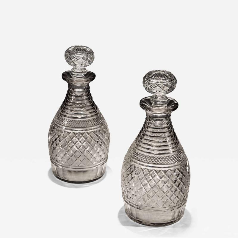 A PAIR OF STEP STRAWBERRY DIAMOND CUT REGENCY DECANTERS