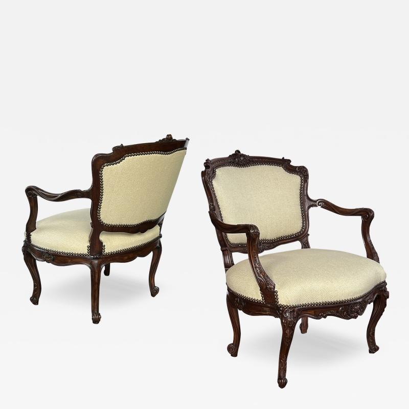 A Pair French Rococo Style Carved Open Arm Chairs