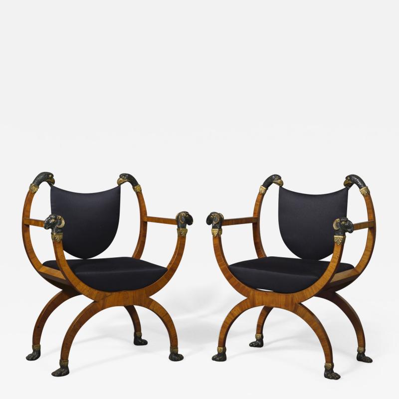 A Pair Of Neoclassical X Form Armchairs With Parcel Gilt And Bronzed Detailing