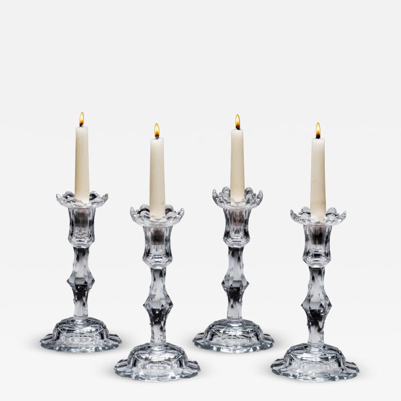 A RARE SET OF FOUR GEORGE III CUT GLASS ROCOCO CANDLESTICKS