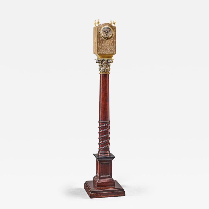 A REGENCY LANTERN CLOCK ON MAHOGANY AND EBONIZED BASE