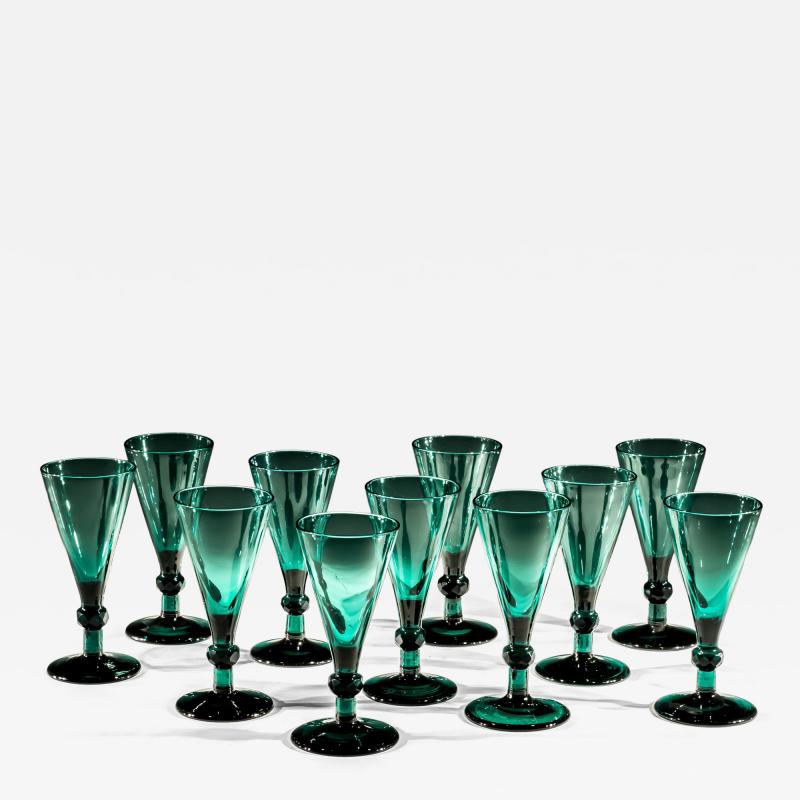 A SET OF ELEVEN GREEN WINE GLASSES