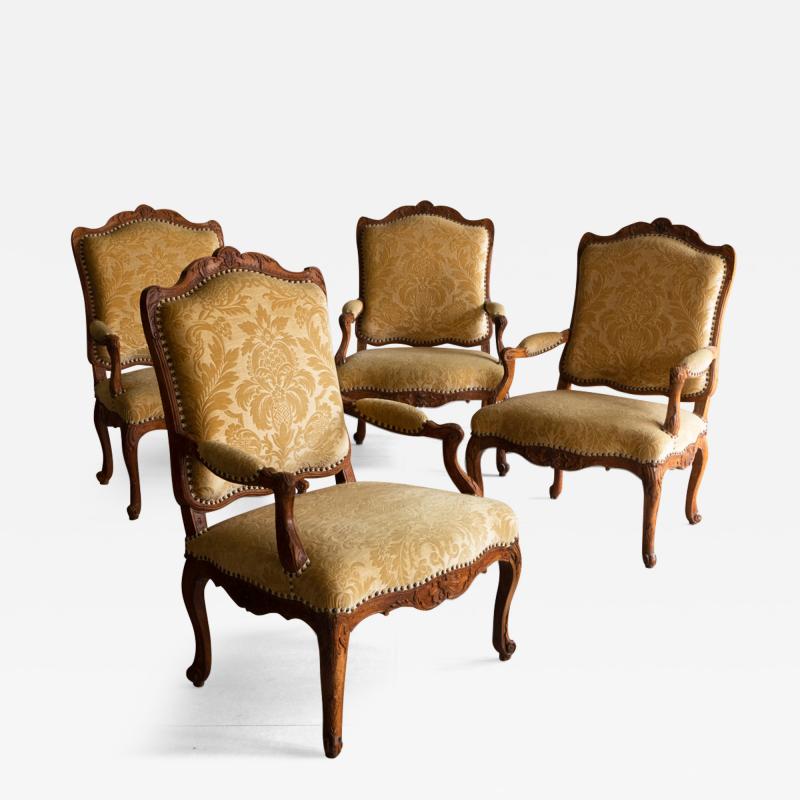 A SET OF FOUR EARLY 18TH CENTURY REGENCE FAUTEUILS LA REINE OR OPEN ARMCHAIRS