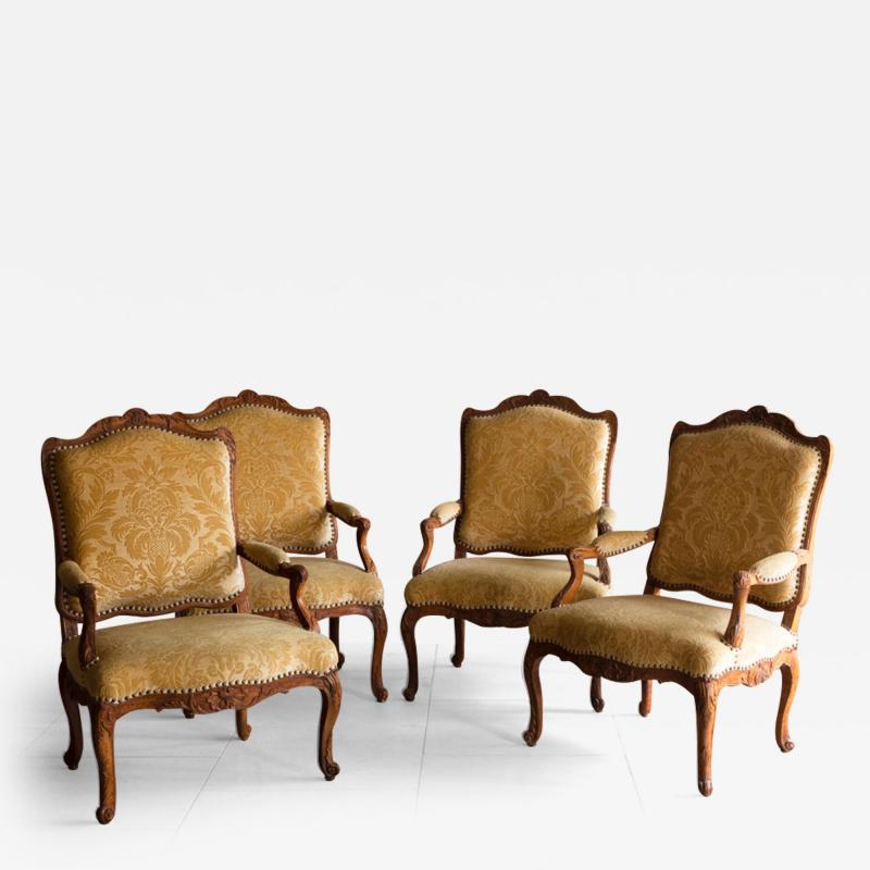 A SET OF FOUR EARLY 18TH CENTURY REGENCE FAUTEUILS LA REINE OR OPEN ARMCHAIRS