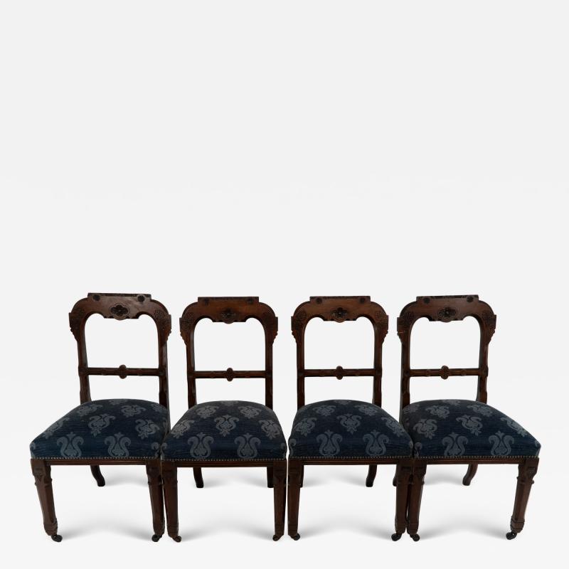 A Set of Four Aesthetic Movement Oak Dining Chairs with Carved Decoration