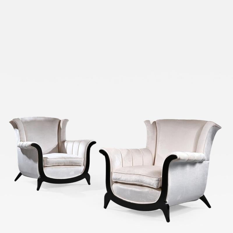 A UNUSUAL PAIR OF FRENCH ART DECO EBONISED ARMCHAIRS IN A CRUSHED VELVET