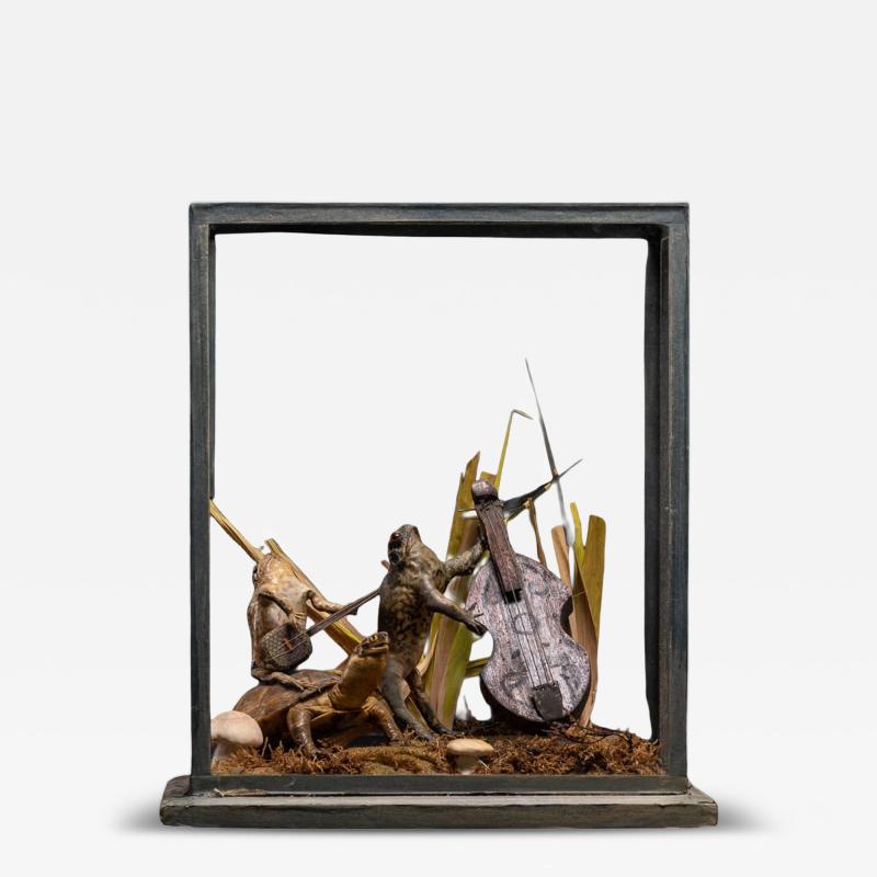 A cased taxidermy display of the Toad and Frog orchestra