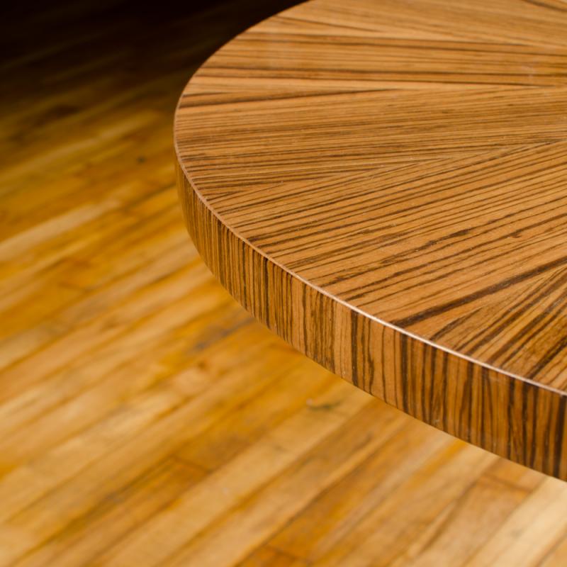 A contemporary round zebra wood table in the Art Deco style.