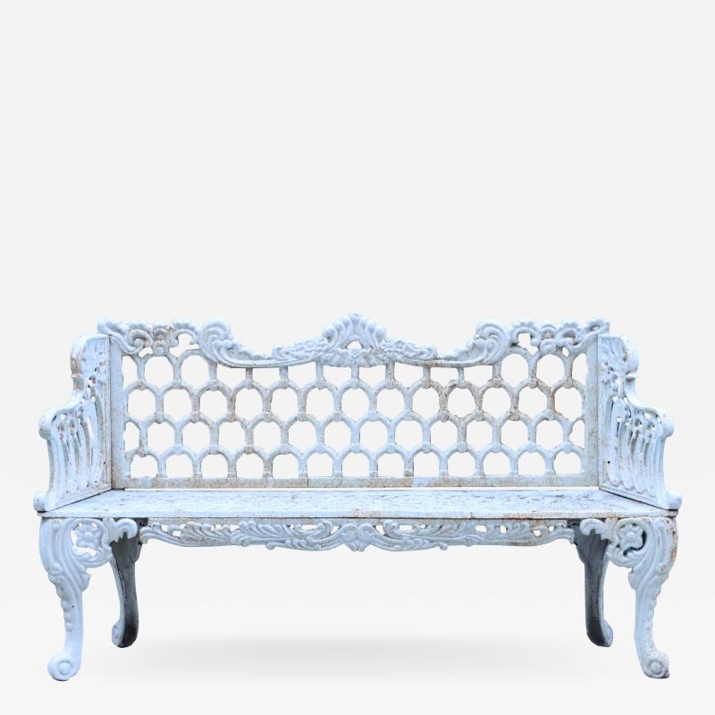 A contemporary white painted cast iron garden bench