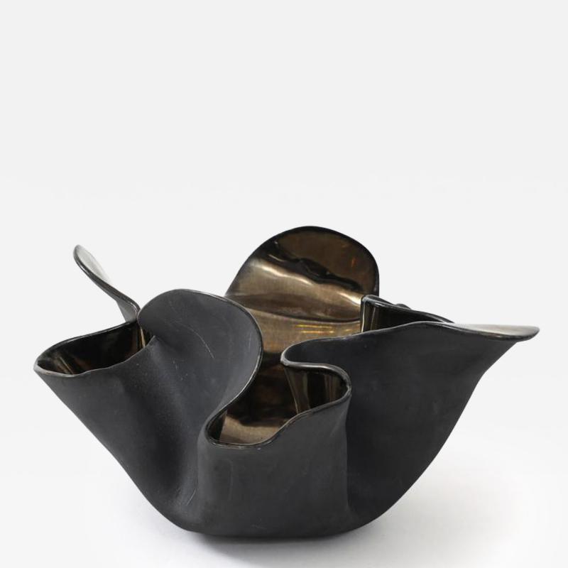 A decorative free form organic bowls in a highly reflective platinum finish